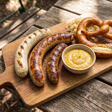 Bavarian sausage platter with Weisswurst Bratwurst mustard pretzel and sauerkraut