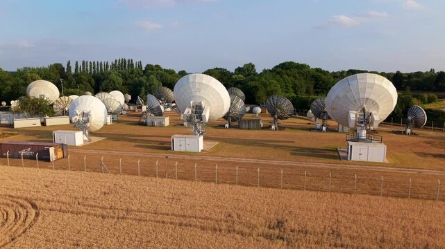 Close-Up Aerial View of Rural Satellite Dish Array in Golden Hour Light, UK