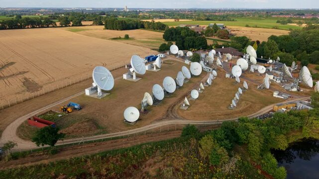 Close-Up Aerial View of Rural Satellite Dish Array in Golden Hour Light, UK