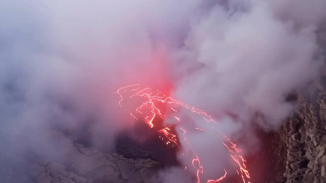 Erta Ale volcano, View of the glowing lava lake inside the crater, with molten rock patterns and dark volcanic rock walls in Zone 2, Afar, Ethiopia.