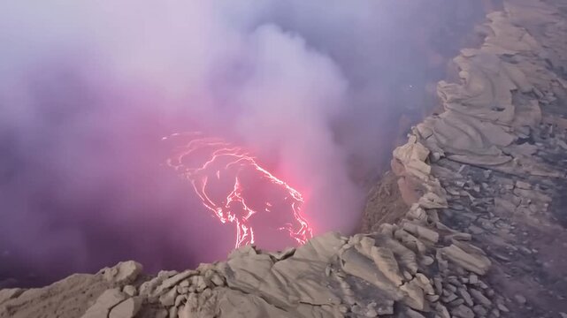 Erta Ale volcano, View of the glowing lava lake inside the crater, with molten rock patterns and dark volcanic rock walls in Zone 2, Afar, Ethiopia.