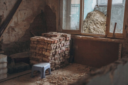 One pile of old peeled bricks in the room.