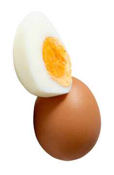 A stack of unpeeled cooked or boiled chicken egg with half and egg yolk isolated on white background with clipping path