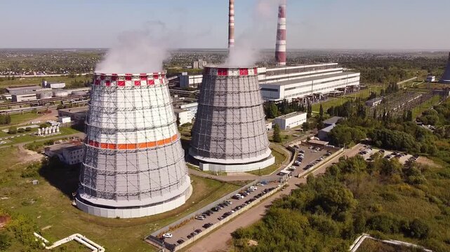 Combined heat and power CHP plant. Thermal power. Residential heat supply. Water cooling towers, big steam and smoke pipes. Thermal power plant aerial view