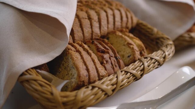 Freshly baked sliced bread nestled in rustic wicker basket lined with beige linen. Warm golden brown tones, soft lighting, cozy kitchen setting. Ideal for food blogs, bakery ads, or breakfast themes