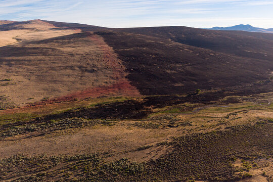 Aerial view of Biscar Fire retardant line on a Lassen County hillside, California, marking where firefighting efforts stopped forward progress.