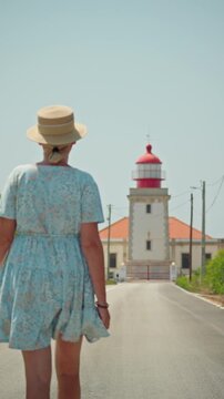 Confident woman walking toward Cabo Carvoeiro Lighthouse in Peniche, symbolizing independence, purpose, adventure, and travel.