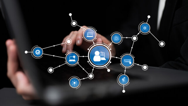 A business professional interacts with a laptop, surrounded by digital network icons that illustrate modern communication, connections, and technology in the workplace. Tessel