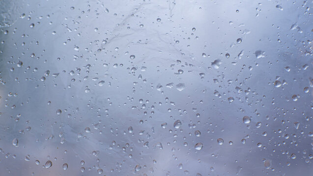 Soft blue-gray Raindrops on Foggy Window Glass Background