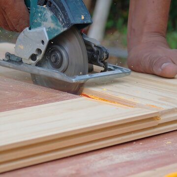 Industrial wood planer machine processing timber planks.