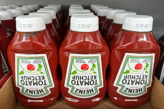 Novi, Michigan, US - 25 Jul 2026 : Upside-down view of Kraft Heinz tomato ketchup plastic bottles neatly arranged in rows on a retail store display shelf.