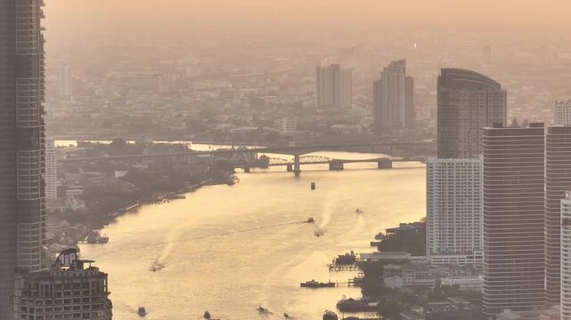 sunset time golden hour bangkok riverside cityscape river traffic aerial panorama 4k thailand 