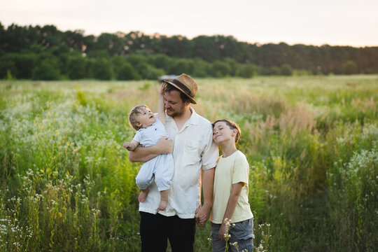 Happy father with two children enjoying summer, Father's Day family concept