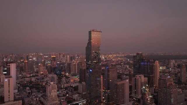 sunset twilight time bangkok city center famous skyscraper tower exterior aerial panorama 4k thailand 