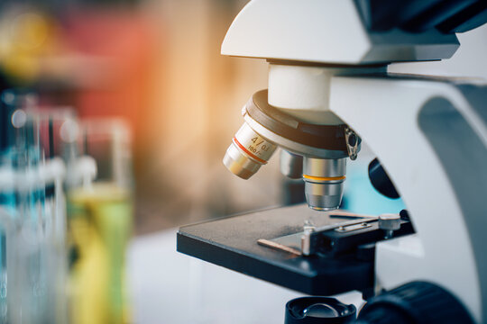 Laboratory research, microscope with lab glassware, science laboratory research and development concept.