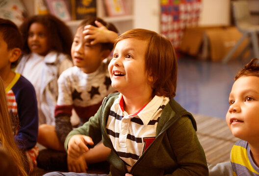 Diverse children engaged in a joyful classroom activity