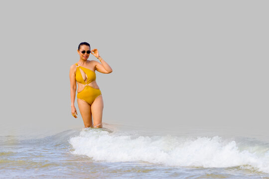 Woman in yellow swimsuit isolated