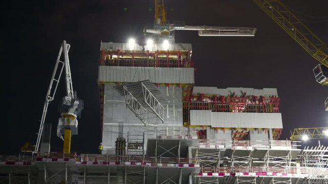 night time illumination abu dhabi modern construction top working cranes up view front panorama 4k united arab emirates
