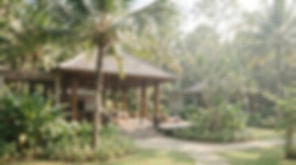 Obraz premium A serene tropical resort with lush greenery and a traditional open-air pavilion.
