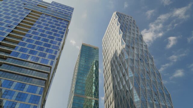 sunny day time abu dhabi city downtown famous office buildings exterior up view slow motion panorama 4k united arab emirates