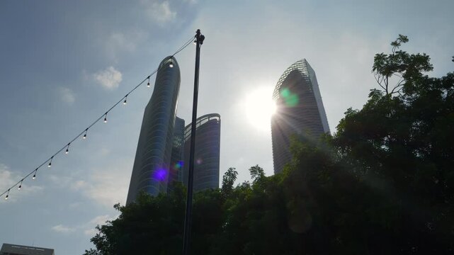 sunny day time abu dhabi city downtown bay modern office buildings exterior up view slow motion walking panorama 4k united arab emirates