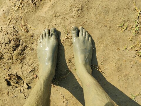 Bare Feet Covered in Coastal Mud on Guliakhali Sea Beach, Sitakunda, Chattogram, Bangladesh