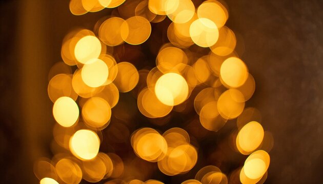 Elegant golden bokeh background with shimmering yellow lights on dark backdrop and copy space.