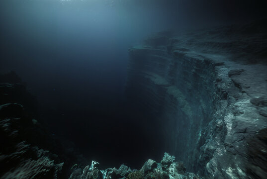 Generated fictional underwater scene with seabed and a large abyss pit.
