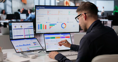 Young Sales Manager Uses Dual Touchscreen Laptop Tracking Customer Leads