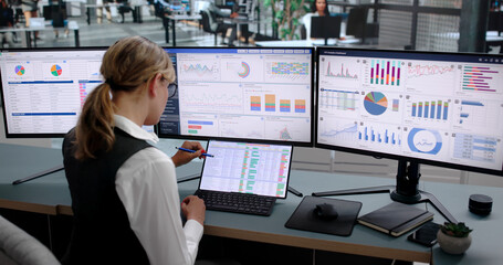 Obraz na płótnie Canvas Young Woman Studies Financial Charts On Laptop