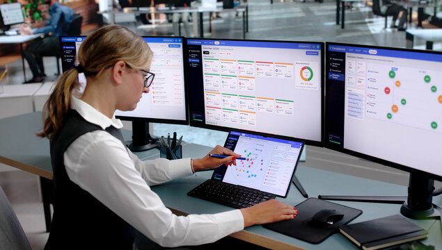 Young Woman Analyzes Corporate Risk Data On Laptop