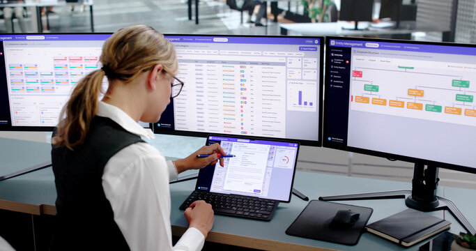 Young Corporate Lawyer Analyzing Ownership Structure Chart On Laptop