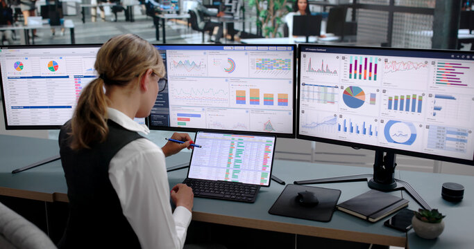 Young Woman Studies Financial Charts On Laptop