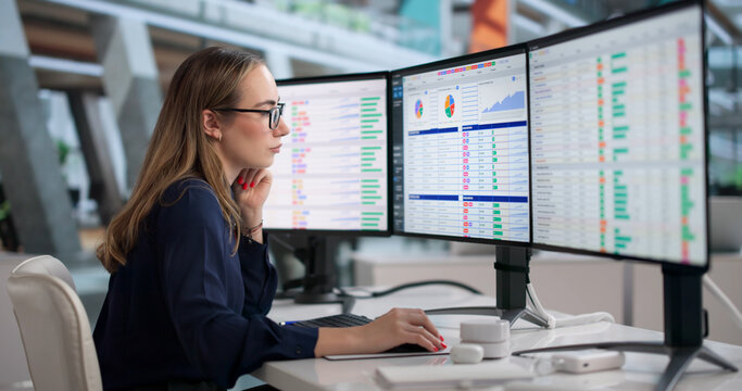 Young Woman At Computer Analyzing Medical Billing Data