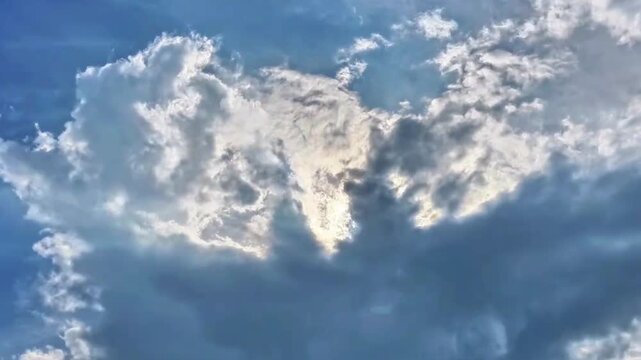 Sunlight Piercing Through Cumulus Clouds