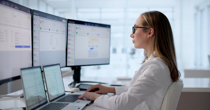 Young Woman Reviewing Patient Medical Claims On Laptop