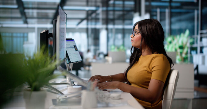 Young African American Woman Uses Laptop To Assess Vendor Risk
