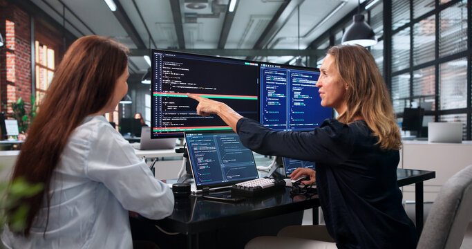 Two Software Developers Work Together On Solving Code Conflicts