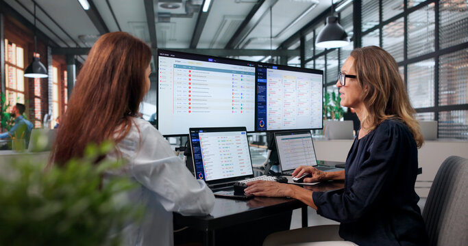 Woman Explains New Software Features To Colleague Working
