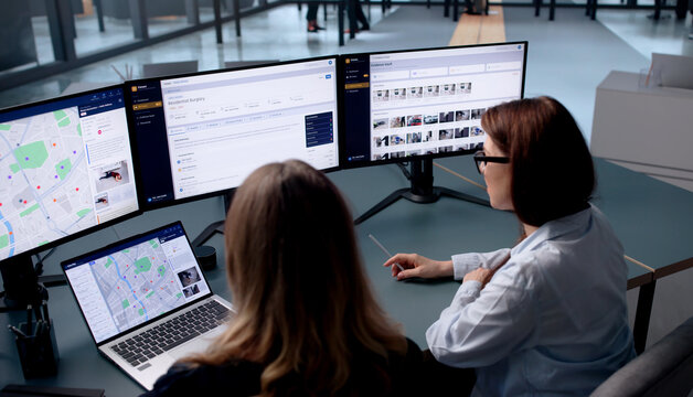 Woman Studies Crime Maps On Laptop Using Geospatial Software