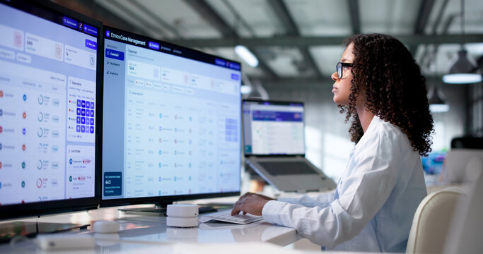 Woman Reviewing Confidential Compliance Case Reports Using Software Dashboard