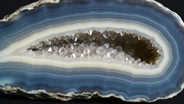 Polished cross section of a banded agate geode with quartz crystal centre, mineral macro