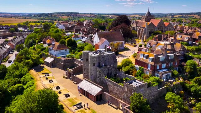 View of Rye cathedral and Ypres Tower rising above historic rooftops in East Sussex, England, in bright daylight; ideal for travel, heritage and tourism marketing