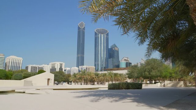 sunny day abu dhabi city downtown exterior new park square slow motion pov walking panorama 4k united arab emirates
