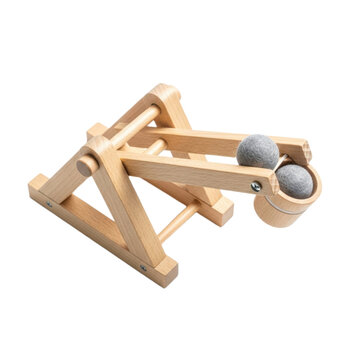 wooden catapult with two felt balls on a white background