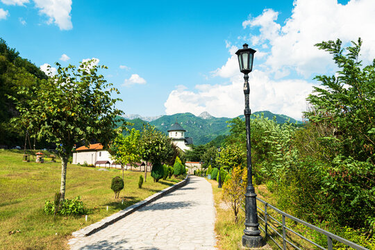 Moraca Monastery with stone path and mountains in Montenegro
