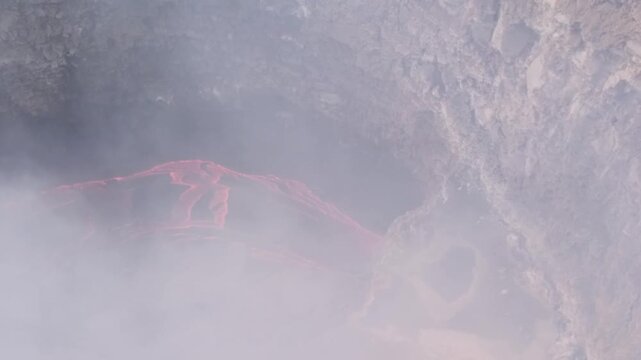 Erta Ale volcano, View of the glowing lava lake inside the crater, with molten rock patterns and dark volcanic rock walls in Zone 2, Afar, Ethiopia.