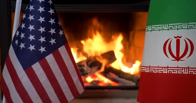 USA and Iran Flags Near Warm Fireplace Symbolizing Diplomacy or Conflict Tensions.