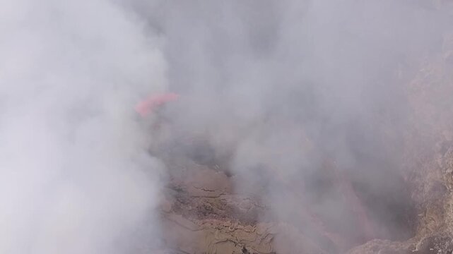 Erta Ale volcano, View of the glowing lava lake inside the crater, with molten rock patterns and dark volcanic rock walls in Zone 2, Afar, Ethiopia.