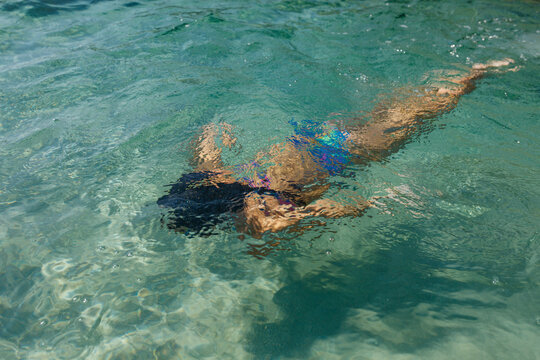 Child Swimming Underwater in Crystal Clear Tropical Sea